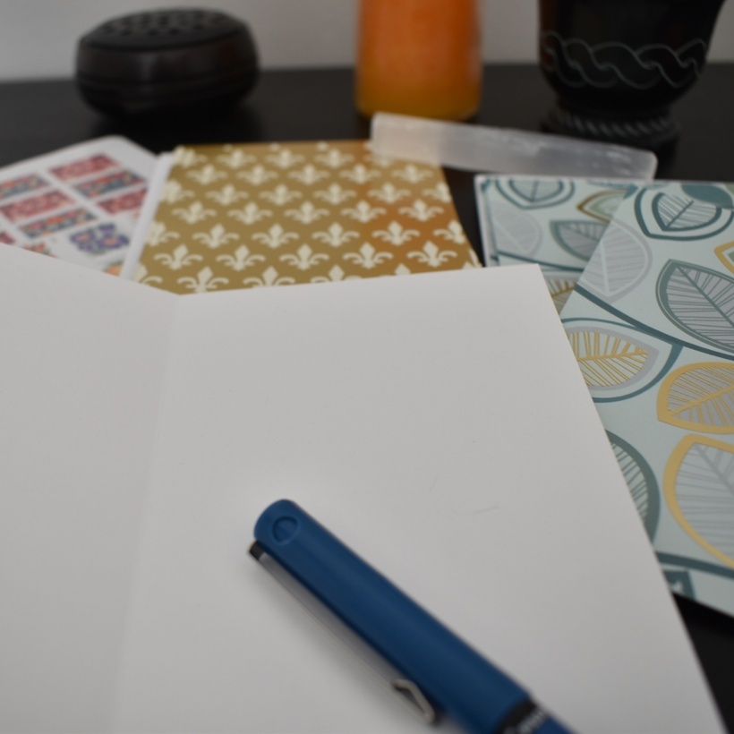 Photo of cards and a pen on a desk.