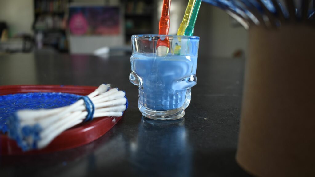 A skull shot glass makes a perfect paint water container.